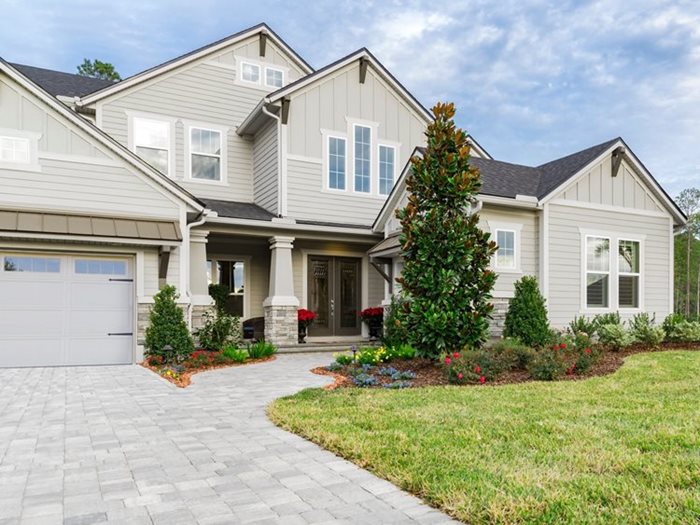 Exterior view of a residential property showcasing different siding styles offered by James Hardie, including lap siding, shingle siding, and vertical siding