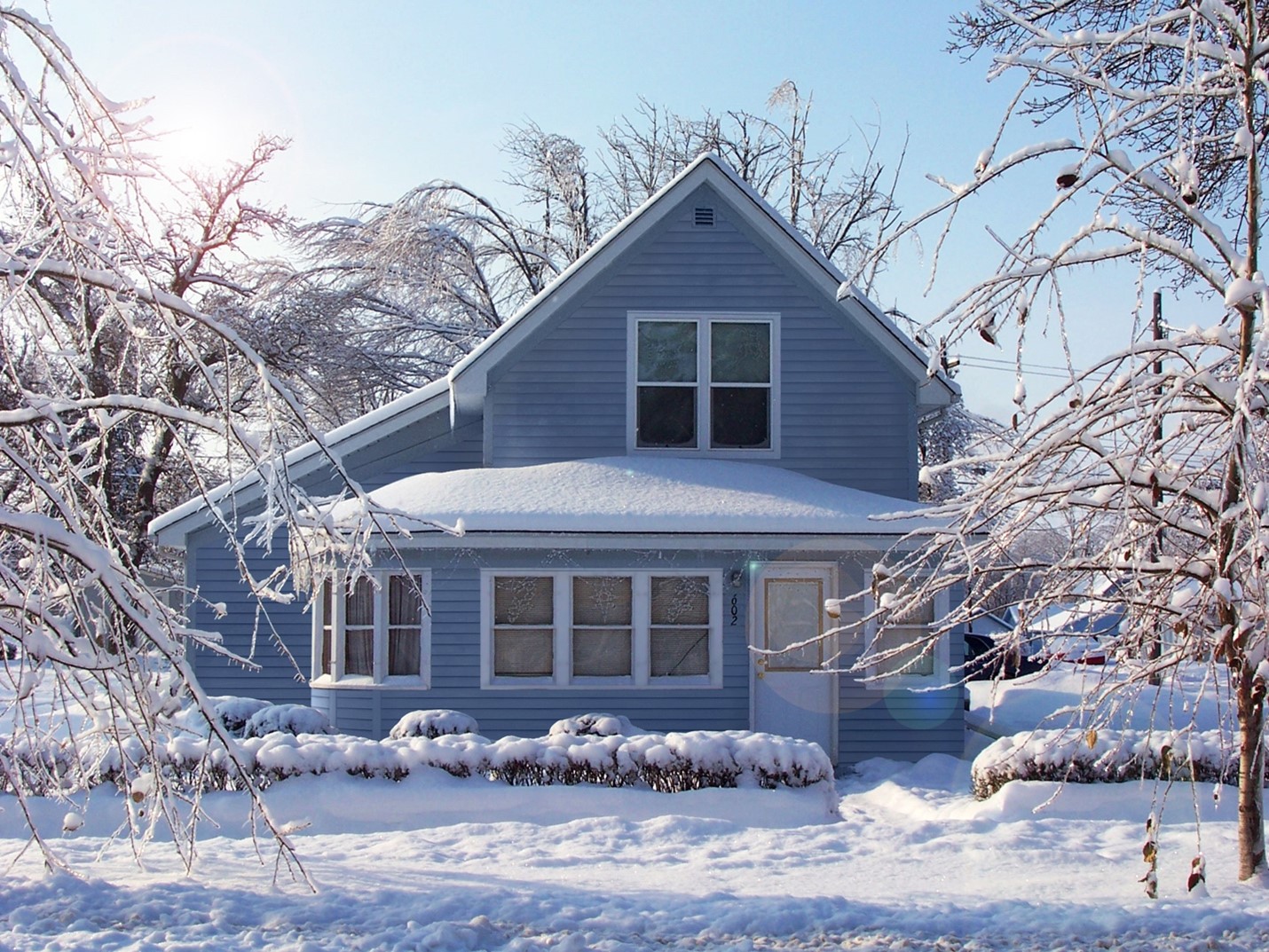 Blue House Covered in Snow with Hardie Siding